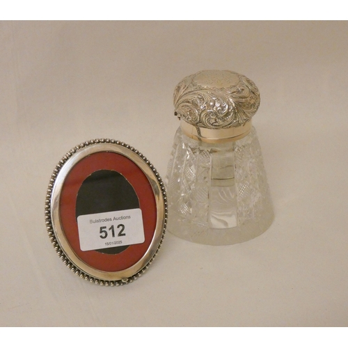 512 - A late Victorian cut glass ink well with hallmarked silver lid and a hallmarked silver oval photogra... 