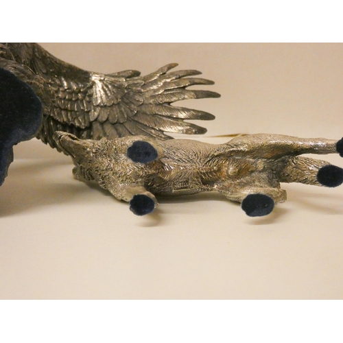 515 - Two silver covered models, one of a Golden Eagle, one of a German Shepherd. Eagle wingspan 25cm acro... 