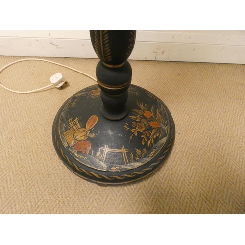 24 - A Chinese black lacquered standard lamp with shade...