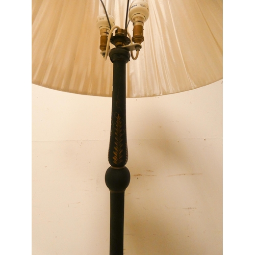 24 - A Chinese black lacquered standard lamp with shade...