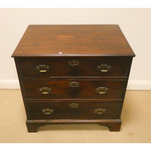 25 - A small Georgian mahogany chest of three long drawers with brass handles standing on bracket feet, 3...