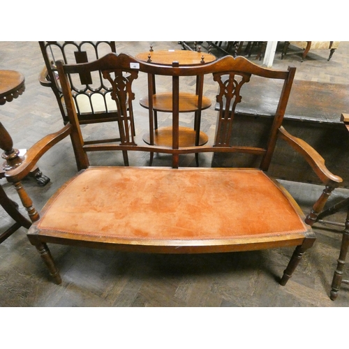 40 - An Edwardian walnut two seater settee with terracotta upholstered seat....