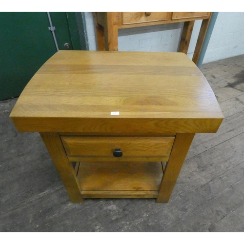 43 - A two tier light oak occasional table with fitted drawer...