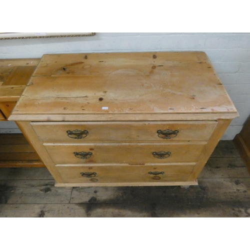 48 - A late Victorian stripped pine chest of three long drawers with brass handles, 3' wide...