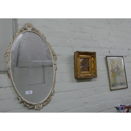 63 - An oval mirror in white and gilt frame, a small gilt framed oil painting and a still life watercolou... 