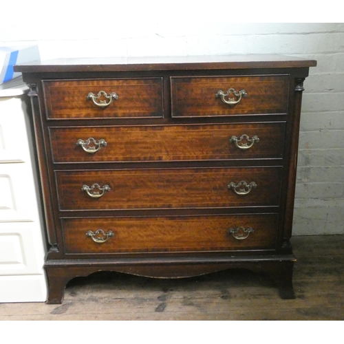 74 - A Georgian style mahogany chest of three long and two short drawers with brass handles and a cross b... 