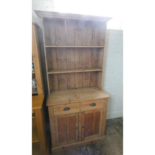 82 - A stripped pine kitchen dresser with shelf back, drawers and cupboards under, 3' wide