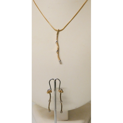 604 - A modern 9ct yellow gold and diamond set pendant necklace and drop earring set, the pendant and earr... 