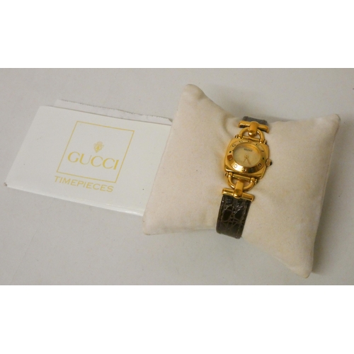 628 - Gucci - ladies quartz wristwatch on brown mock croc strap, with warranty card & purchase receipt.