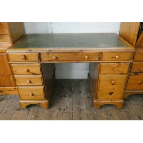 120 - A pine knee-hole pedestal desk fitted eight drawers with green leather top, 4' wide