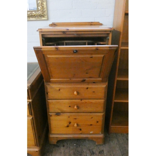 123 - A small modern pine bureau with fitted interior and three drawers under, 23