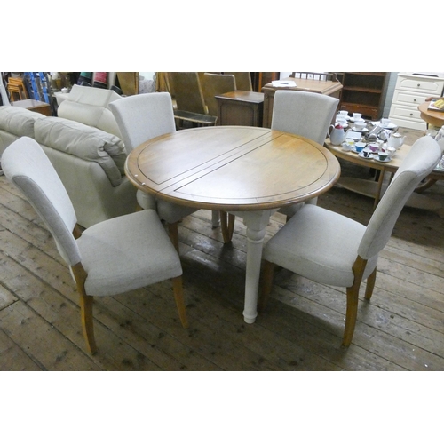 130 - A modern circular painted and light oak topped dining table with foldaway centre leaf together with ... 