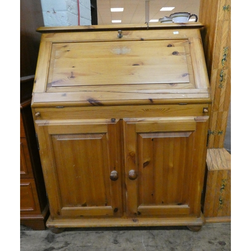 161 - A modern pine bureau with cupboards under, 2'6