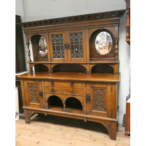 181 - An Edwardian oak dresser style sideboard with leaded glazed and mirror cabinet back, two drawers and... 