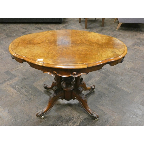 167 - A Victorian walnut shaped centre table on a cluster column base