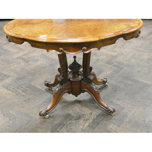 167 - A Victorian walnut shaped centre table on a cluster column base