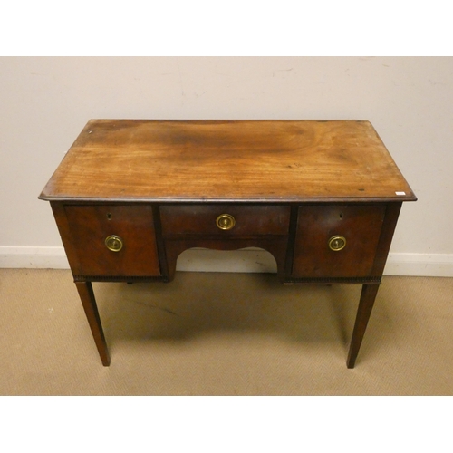 185 - An Edwardian mahogany hall or writing table, fitted one central drawer and deep drawers each side wi... 