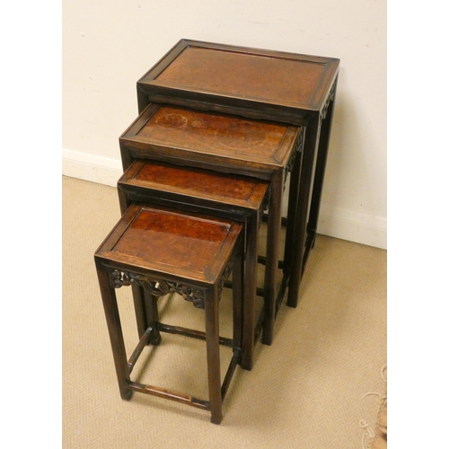 189 - A set of four Chinese carved hardwood rectangular coffee or occasional tables