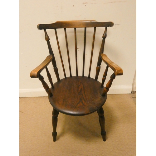 303 - A Windsor elbow chair with circular elm seat