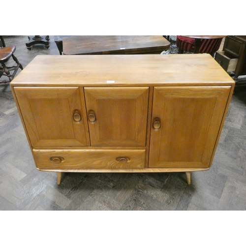 311 - An Ercol elm sideboard fitted three cupboards and one drawer, 45