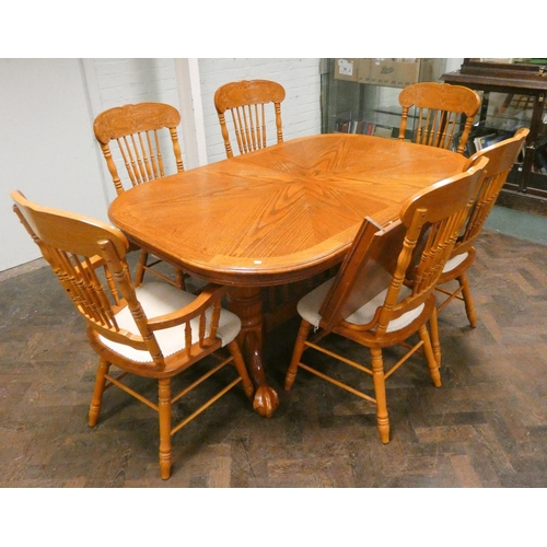 318 - A large Spanish style carved dining suite comprising of a large oval extending dining table and six ... 