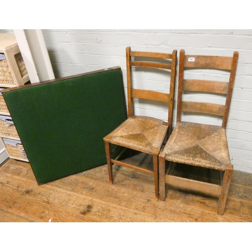 321 - A folding card table and a pair of ladder backed rush seated chairs