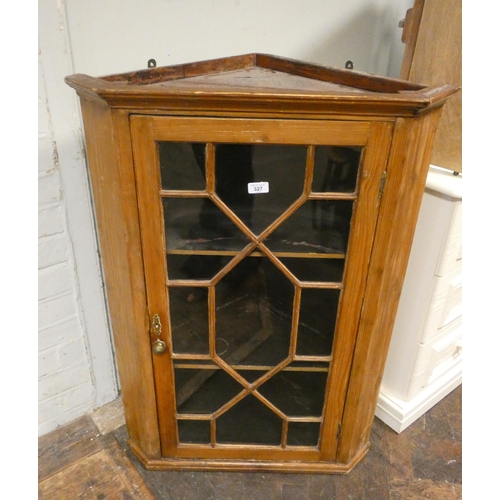 327 - An antique stripped pine hanging corner cabinet with astragal glazed doors