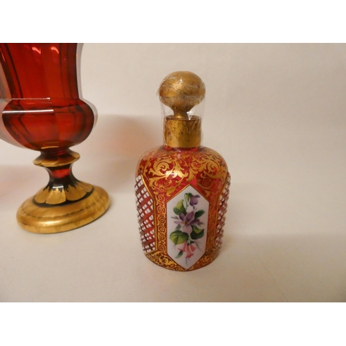 239 - A Bohemian ruby glass and gilt decorated miniature urn shaped vase together with a smaller pair of u... 