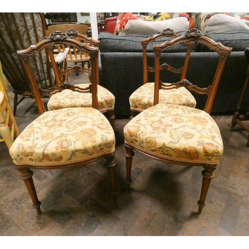 344 - A set of four late 19th century carved walnut dining chairs with gold tapestry over stuffed seats