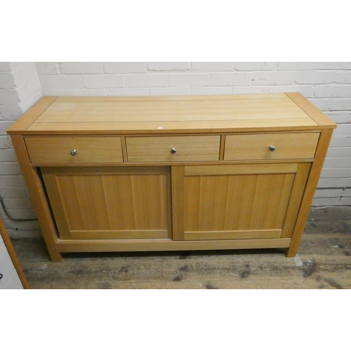 21 - A modern light oak sideboard fitted three drawers and sliding door cupboards, 4'6