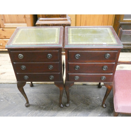 33 - A pair of reproduction mahogany three drawer bedside chests standing on cabriole legs with green lea... 