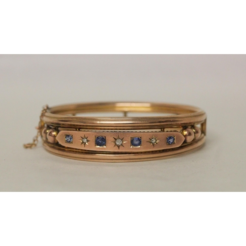 541 - Late 19th century 9ct rose gold sapphire and diamond bangle. unmarked. With box clasp and safety cha...