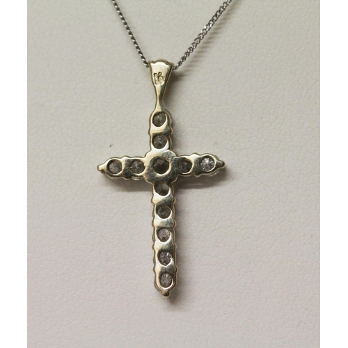 543 - A 9ct gold diamond set cross pendant, on fine white gold chain. 2.2g...