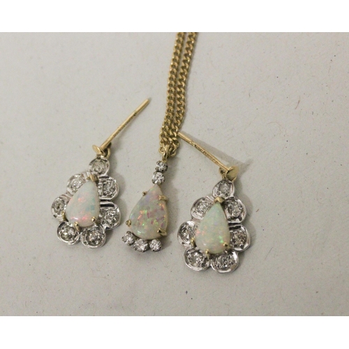 545 - A pretty 18ct yellow gold opal and diamond set suite of jewellery, comprising tear drop shaped earri...