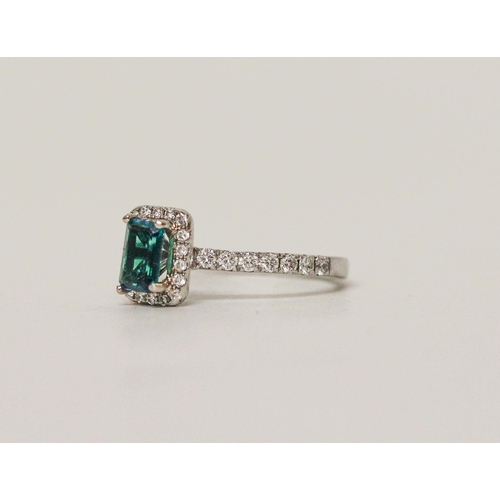 553 - A modern emerald and diamond rectangular cluster ring, platinum band with diamond shoulders. Ring si... 