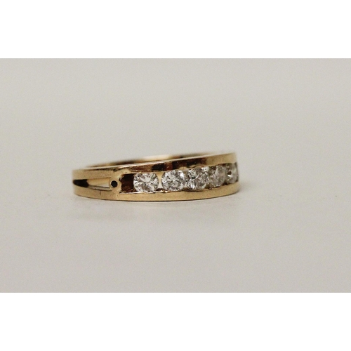 571 - A large modern 18ct yellow gold diamond half hoop eternity ring, channel set with seven brilliant cu...