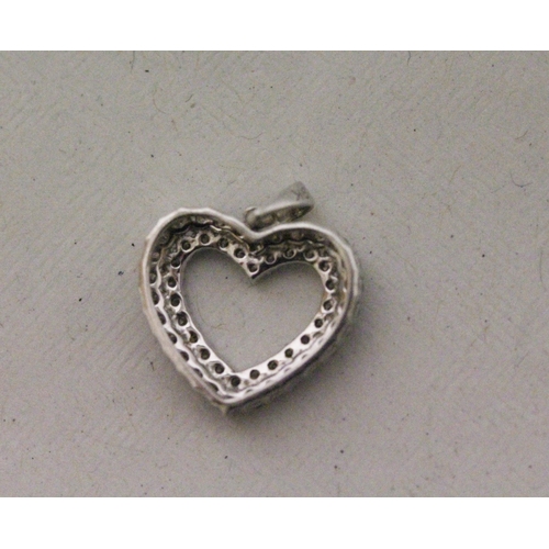 575 - A 9ct modern white gold diamond set open heart pendant, 1.5 grams