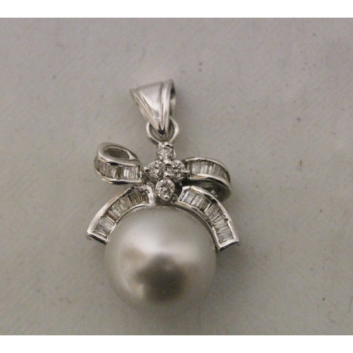 576 - A modern cultured pearl and diamond set ribbon bow design pendant, total length including loop 27mm,... 