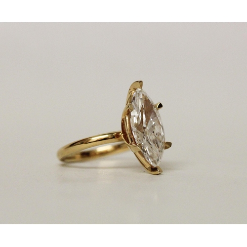 579 - A large and impressive lab grown diamond solitaire ring, the claw set marquise brilliant cut diamond... 