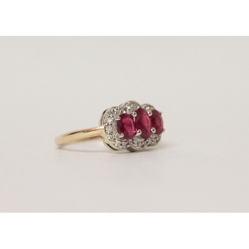 583 - A three stone ruby and diamond triple cluster ring on 18ct yellow gold band, ring size K, 4.1 grams