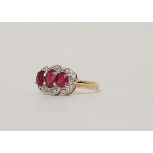 583 - A three stone ruby and diamond triple cluster ring on 18ct yellow gold band, ring size K, 4.1 grams