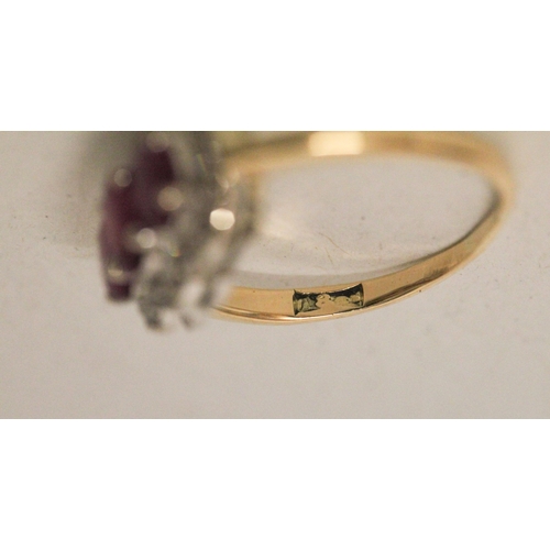 583 - A three stone ruby and diamond triple cluster ring on 18ct yellow gold band, ring size K, 4.1 grams