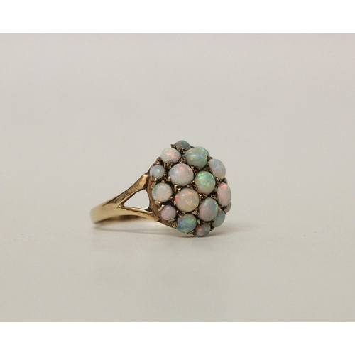 588 - A circular opal bombe cluster dress ring on hallmarked 9ct gold band, ring size N, 3 grams