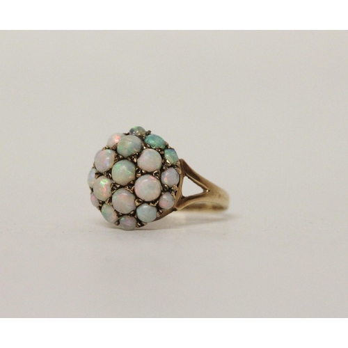 588 - A circular opal bombe cluster dress ring on hallmarked 9ct gold band, ring size N, 3 grams