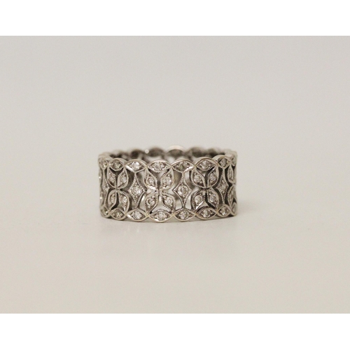 597 - A modern 18ct white gold diamond set wedding band or eternity ring, ring size L, 4.4 grams