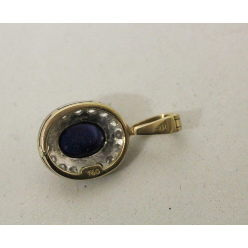 599 - A modern oval cabochon sapphire and diamond cluster pendant, marked 750, 2.7 grams