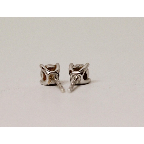 615 - A pair of diamond ear studs in 9ct white gold