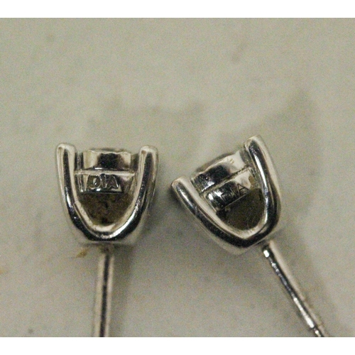 615 - A pair of diamond ear studs in 9ct white gold