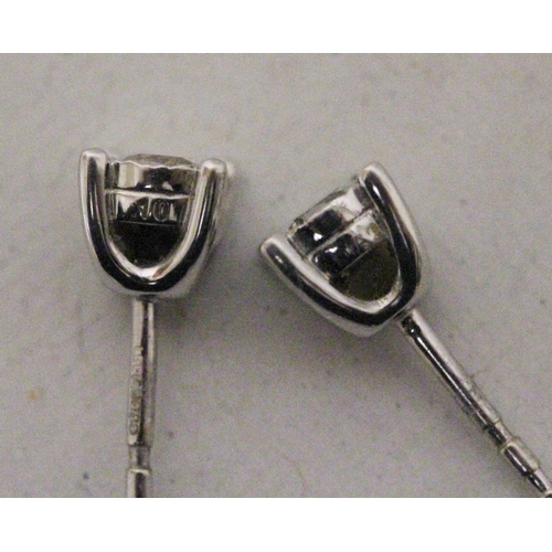 615 - A pair of diamond ear studs in 9ct white gold