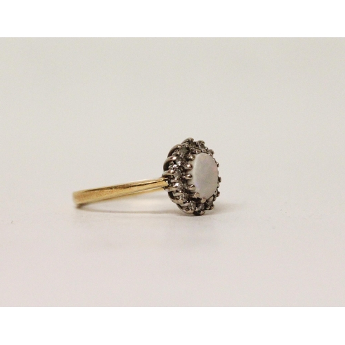 617 - An oval opal and diamond cluster ring on hallmarked 18ct gold band. Ring size K, 3.3 grams